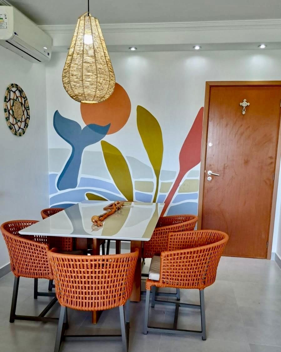 Dining room mural: whale tail and foliage in soft blues and ochres · Souluarte